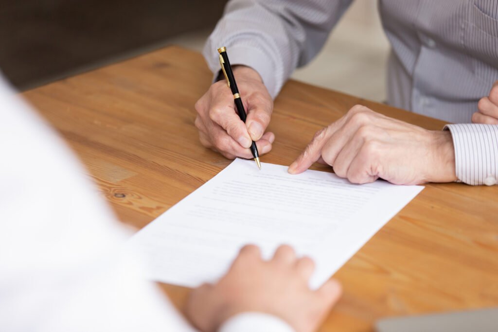 Close Up Elderly Businessman Hand Holding Pen, Put Signature On Paper
