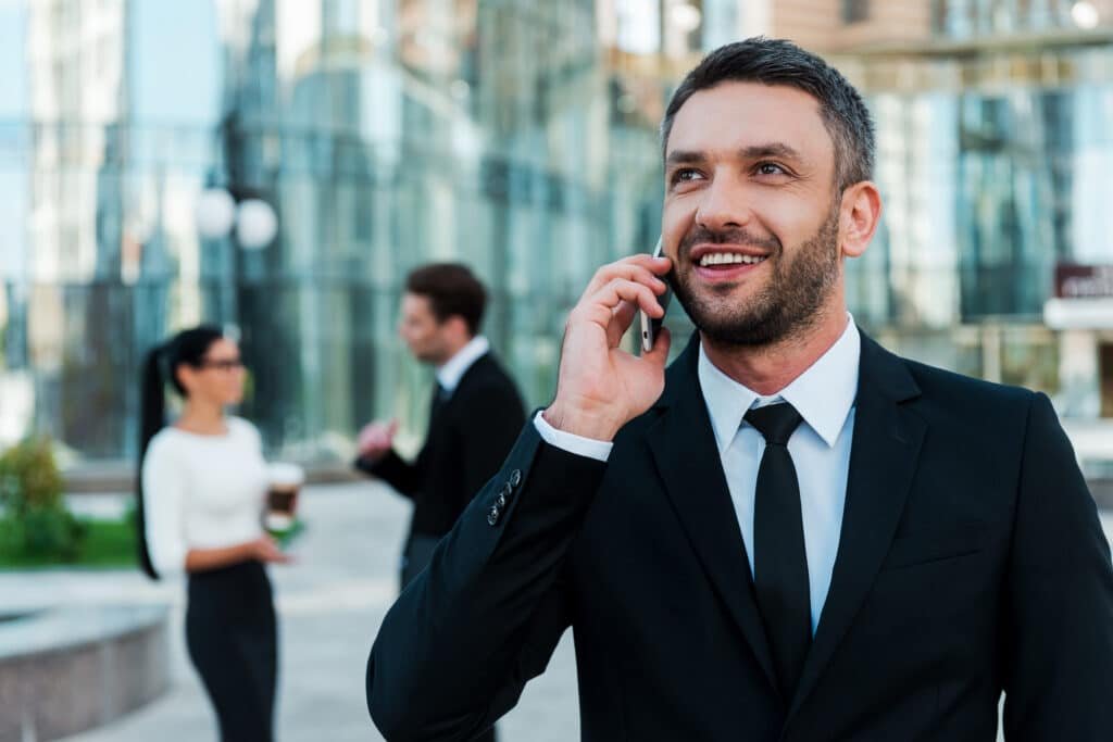 Always In Touch With His Clients. Cheerful, Young Businessman Talking